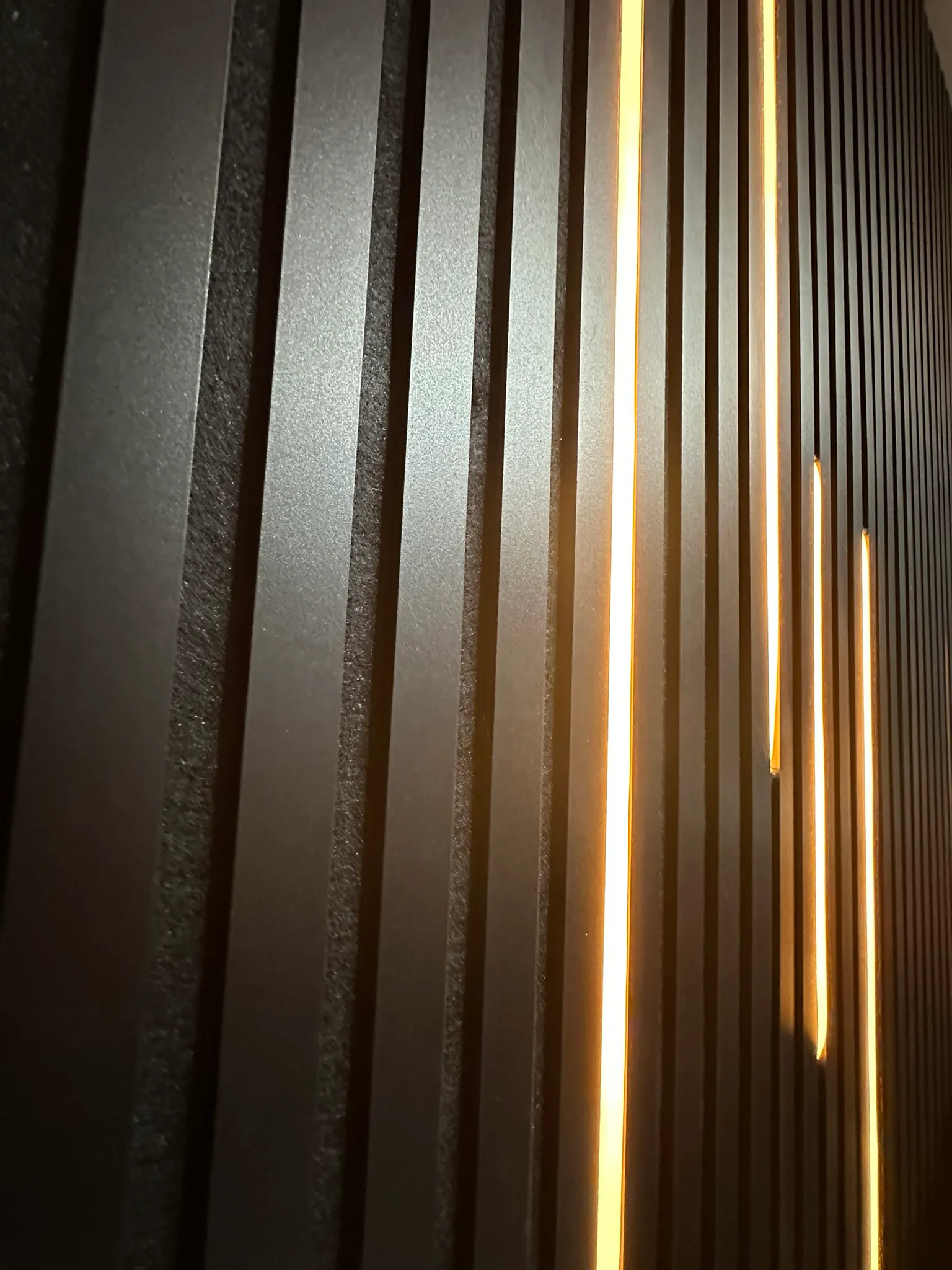The same panels seen along their length, each line of light stopping at a different height.
