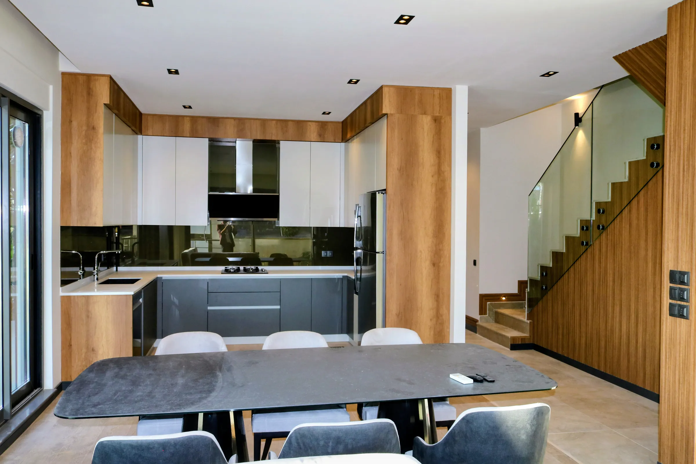 The kitchen and dining area, the stair rising behind it.