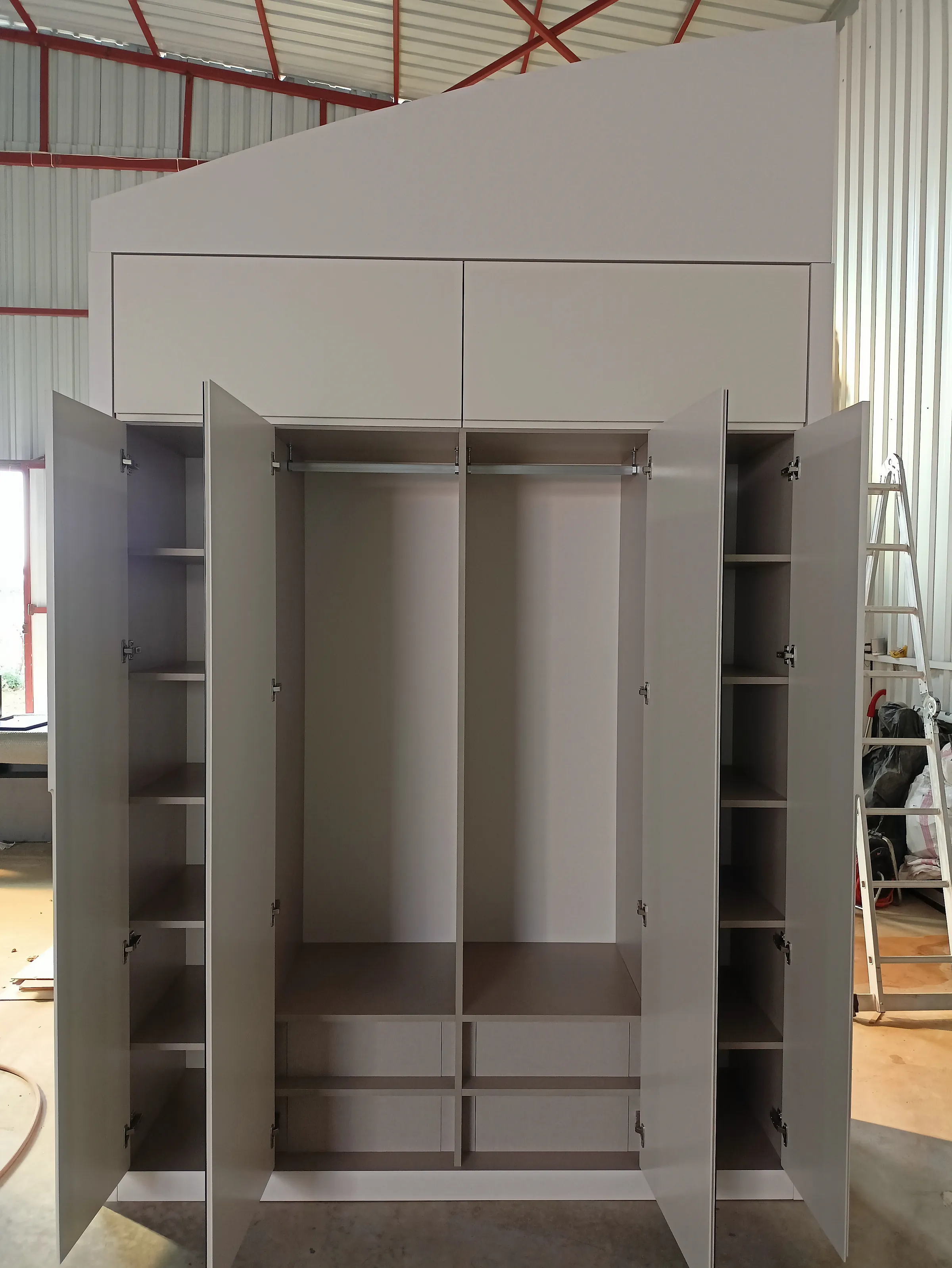 A wardrobe standing part-built, before its doors go on.